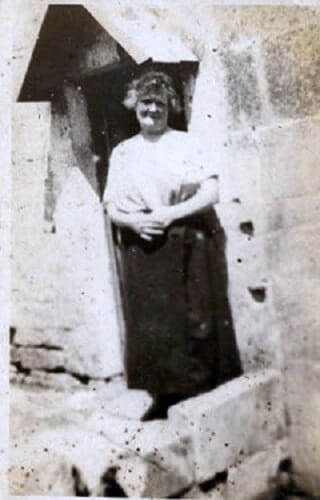my grandmother standing in the doorway of her home in quarry vale